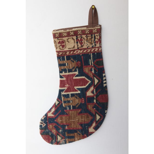 Celebrate the season with this one-of a kind Christmas stocking, handcrafted from a genuine antique tribal rug. Rich in...