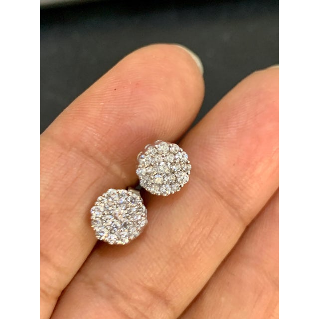 A sweet, shimmery style for any day of the week. These stud earrings blossom floral clusters of Approximately 1.6 ct. t.w....
