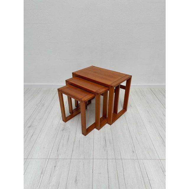 Beautiful vintage set of 3 danish nesting tables from the 1970s. Elegant mid-century design with warm teak wood grain and...
