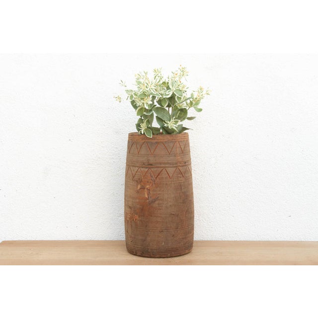 A powerful piece of primitive craftsmanship, this tall cylindrical vessel was hewn from a single solid log. Originating...