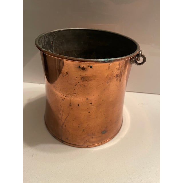 Vintage 19th-century copper and brass bucket, frequently used as a decorative fireside log or kindling bin. Originally...