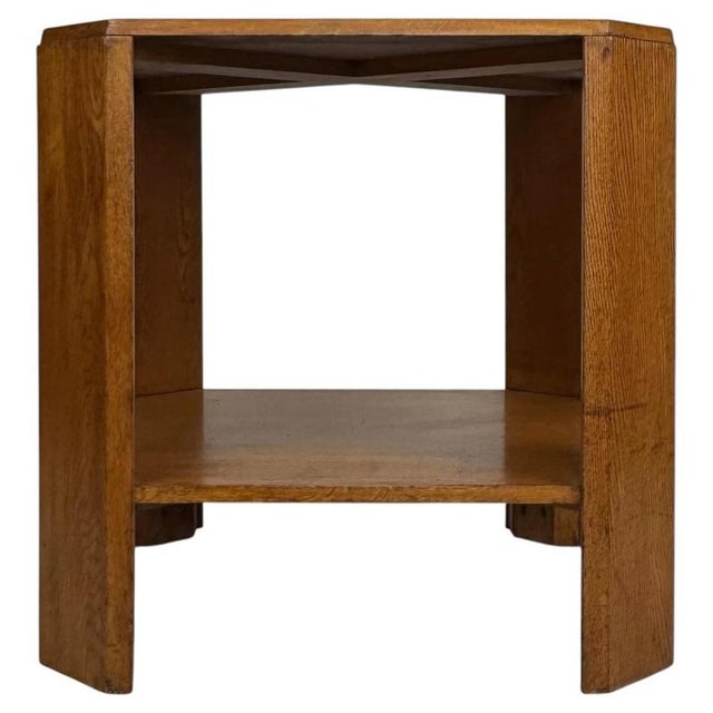 A charming early 20th-century English side table, finely crafted from golden oak and distinguished by its compact square...