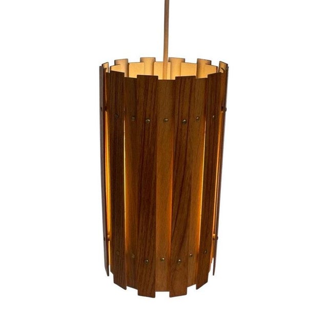 Vintage ceiling mounted fixture made from teak wood and a white inside. It has a beautiful glow due to the overlap of...