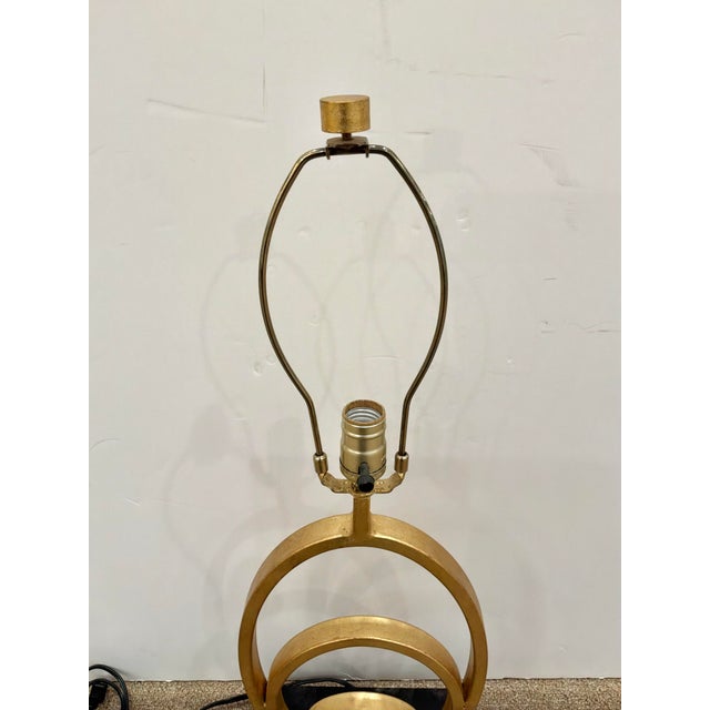 Stylish Currey & Co Firelight Lamp with Gold Leaf finish on a rectangular black base. Original Retail $960. Showroom floor...