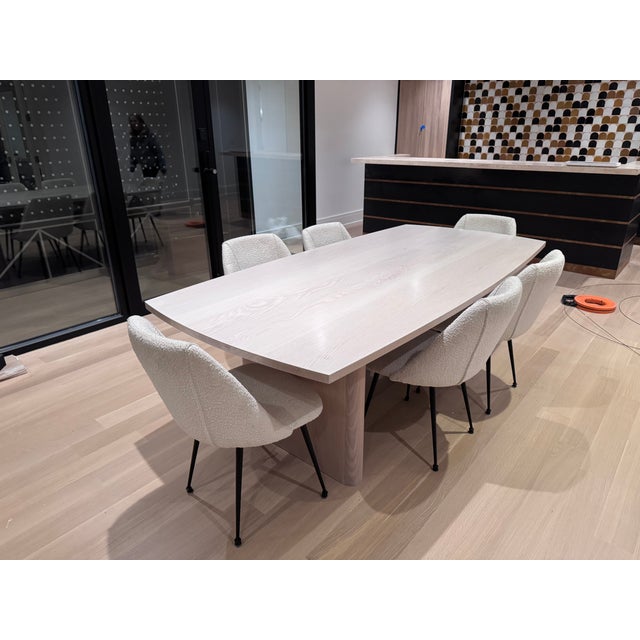 Beautiful custom dining table crafted from solid white oak with a refined white ceruse finish that highlights the natural...