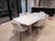 Beautiful custom dining table crafted from solid white oak with a refined white ceruse finish that highlights the natural...