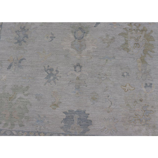 Modern Tribal Oushak With a Cream Border and Light Gray-Blue Background For Sale - Image 9 of 13