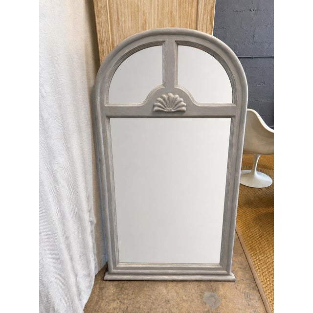 Elegant vintage 1070s arched mirror with a distressed gray wood finish, carved shell detail, and architectural divided...