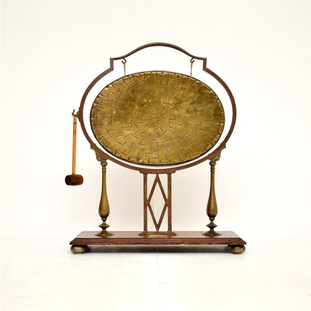 A wonderful antique Edwardian brass and oak dinner gong, made in England and dating from 1900-1910. It is a wonderful...