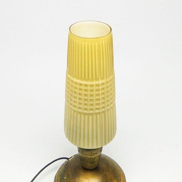 The bedside lamp comes from Poland in the 70's. It has a glass shade and metal construction. It is in good condition, the...