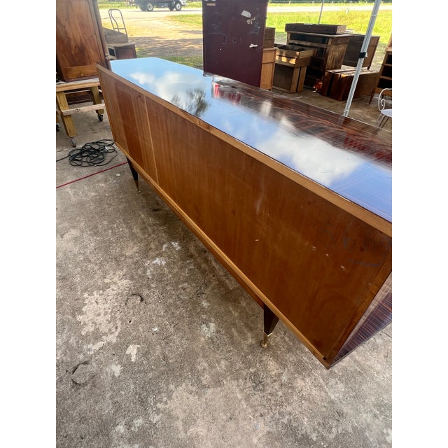An exceptional French Art Deco Modern sideboard crafted in the 1940s and veneered in striking Macassar ebony. Showcasing...