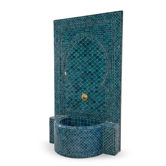 This stunning Moroccan wall fountain is a masterwork of traditional Moorish craftsmanship, featuring hand-cut Zellige...
