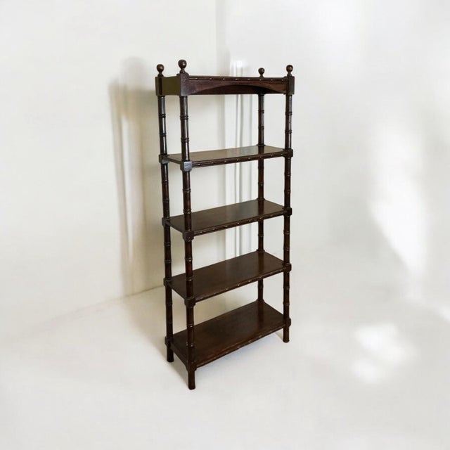 This is a regency style carved fruitwood faux bamboo shelf / etagere / bookcase. The shelves are about 11.75” deep, and 14...