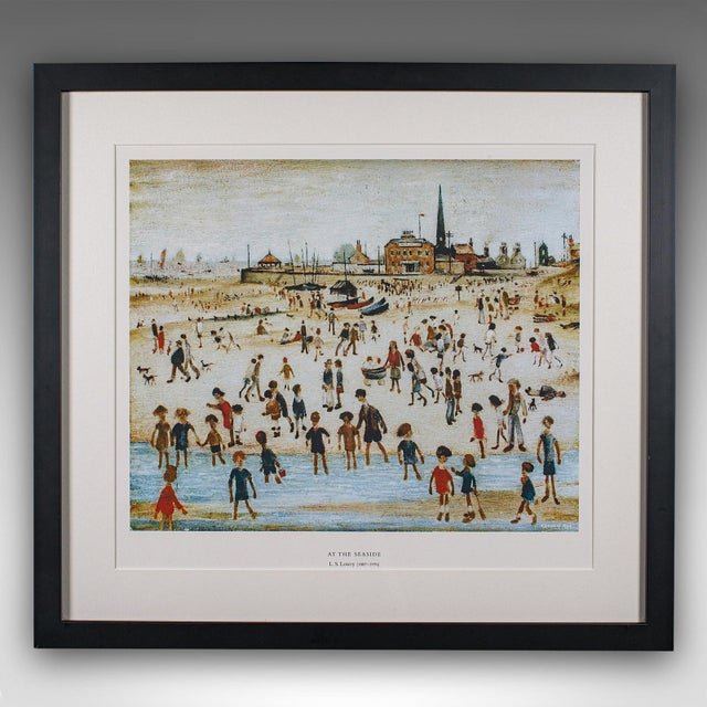 This is a vintage print of At the Seaside by L.S. Lowry. An English, framed art reproduction of the fabled painter's...