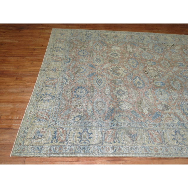 An early 20th century decorative Persian Tabriz rug with a classic all-over design in soft earth tones. 8'4'' x 11'4''...