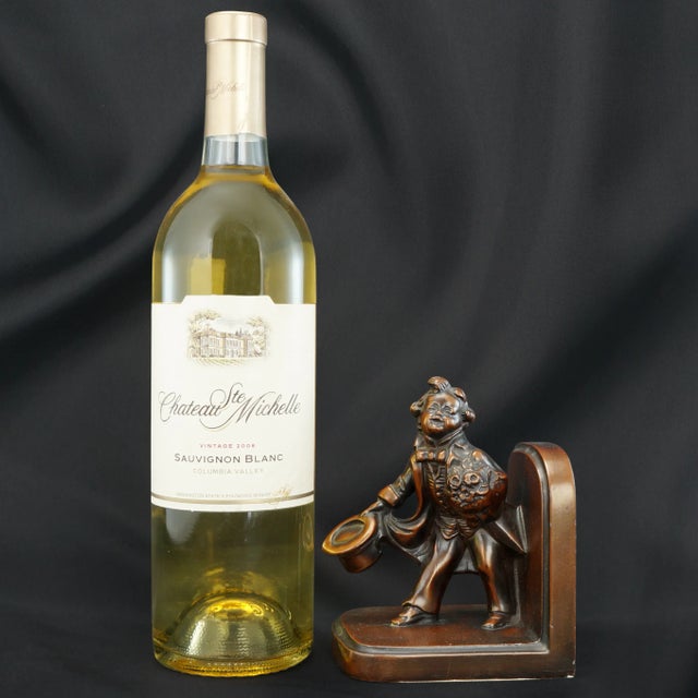 A bookend with a fanciful depiction of a little boy with a bouquet of flowers for his little girlfriend. The casting is...