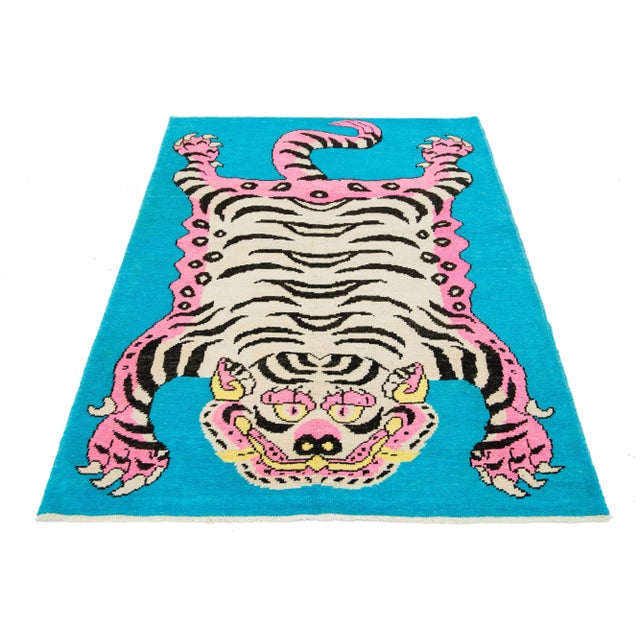 This Turkish Art Deco wool rug features a beautiful tiger pictorial design with a blue field and pink and beige accent...
