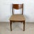This mid-century walnut side chair offers a sculptural profile that feels both sophisticated and timeless. The gracefully...