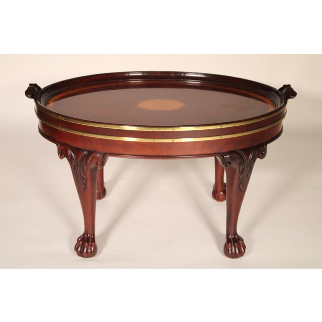 George II style mahogany, satin wood and brass coffee table, made by Baker Furniture Co., circa 2000. With an oval...