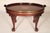 George II style mahogany, satin wood and brass coffee table, made by Baker Furniture Co., circa 2000. With an oval...