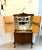 An antique burr walnut cocktail cabinet dating to the early 20th century, featuring beautifully figured burr walnut...