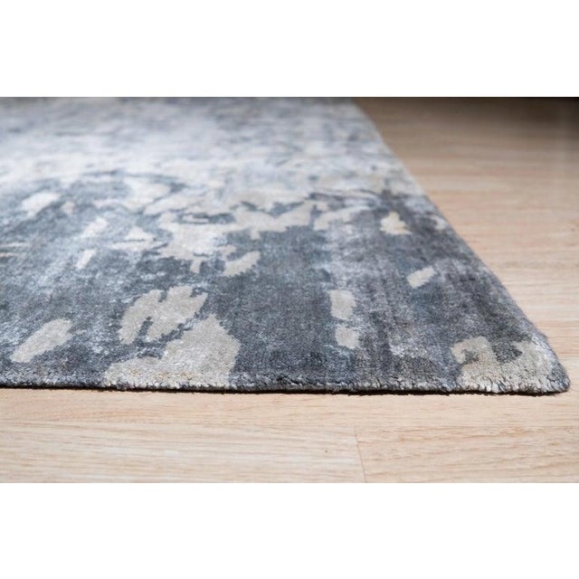 This ivory beige cream white rug represents a modern take on Oushak rugs, constructed entirely from viscose. It features a...