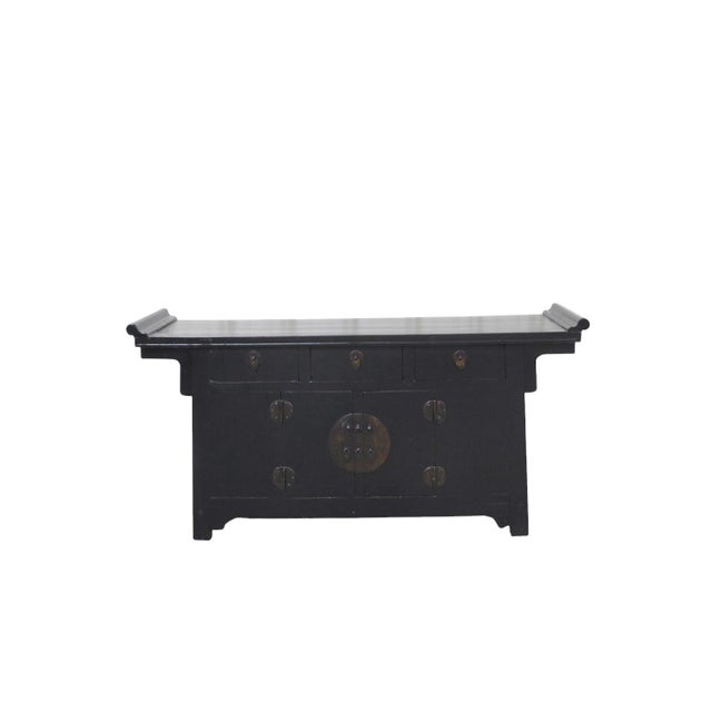 This late 19th century coffer-style elm sideboard is crafted from solid elm wood. The top features traditional upturned,...
