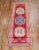 One of a kind, mid 20th-century Hand-knotted Turkish Wool Runner with 3 medallions on a bright red field. Professionally...