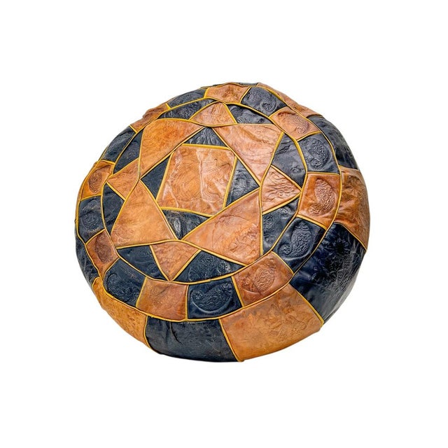 Moroccan pouffe from the 1970s, black and cognac-coloured leather. Patchwork design with (faded) Moroccan motifs in...