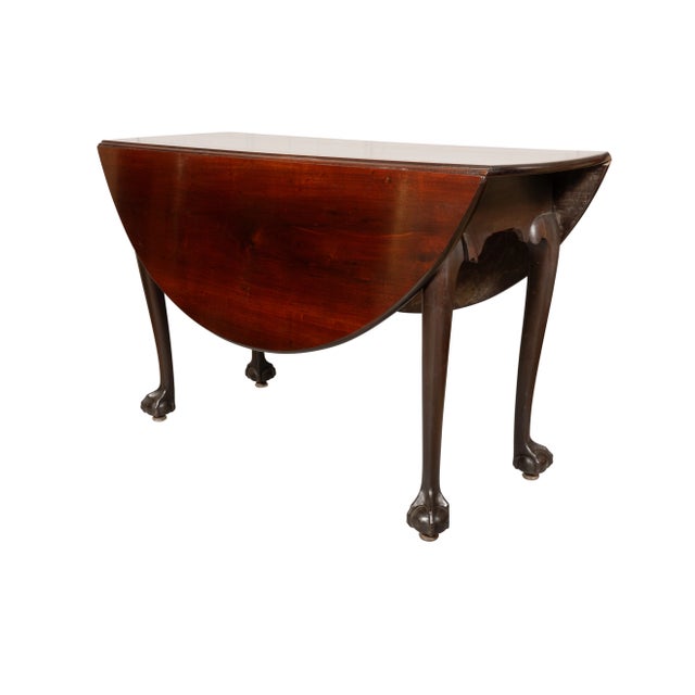American Chippendale Mahogany Dropleaf Table with circular top with hinged leaves raised on cabriole legs with ball and...