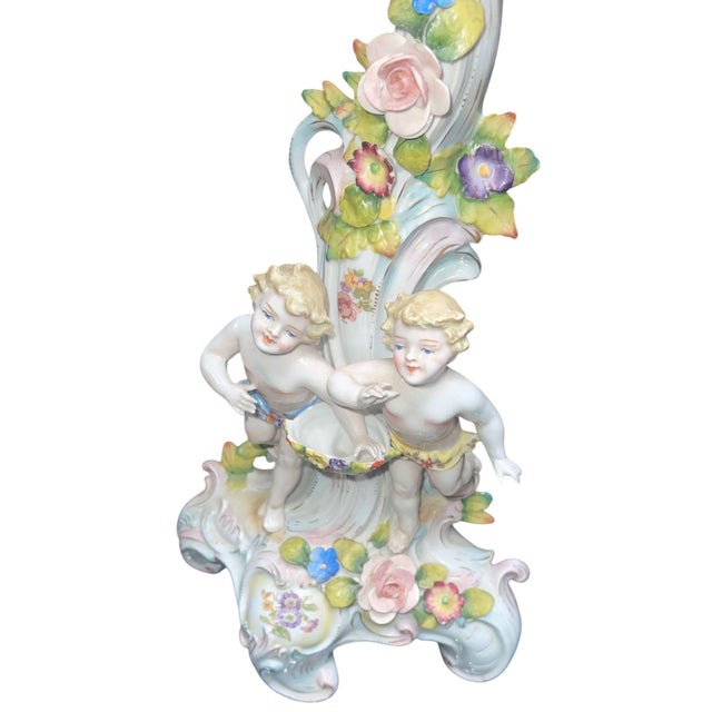An elegant pair of Meissen-style porcelain five-light candelabras, beautifully hand-decorated in the Rococo taste with...