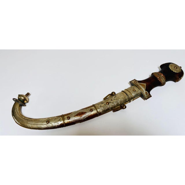 Large Moroccan Khoumaya / Jambiya Dagger with Ornate Sheath, circa 1950s A striking and highly decorative Moroccan dagger,...