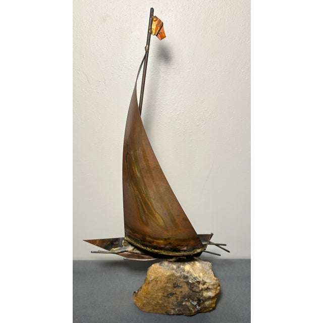 Up for sale is a Vintage 1970’s American Brutalist Welded Copper/Brass Metal Sailboat on Stone Base Sculpture by Bijan...