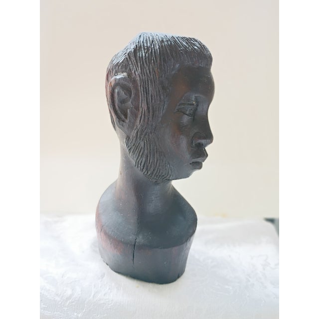 This is a striking, vintage hand-carved African bust meticulously sculpted from dense, heavy ebony hardwood. The piece...