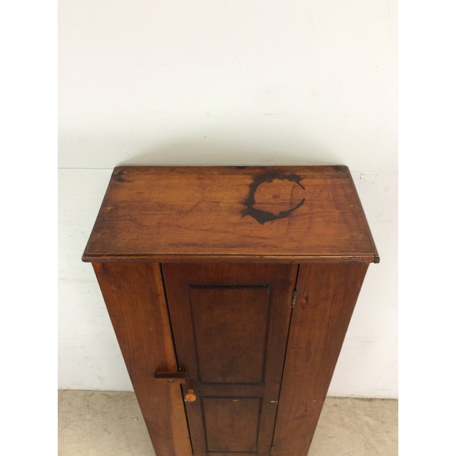 This antique cabinet features solid wood construction, original knotty pine finish, cabinet door with wood latch, and four...