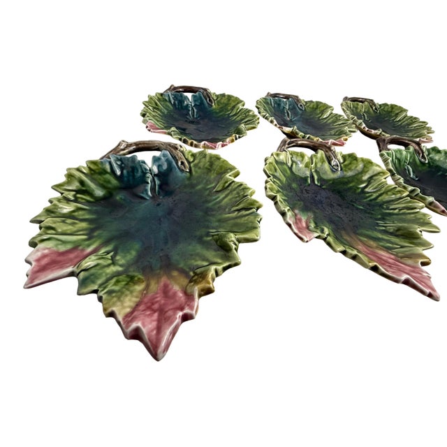 A stunning set of six antique majolica leaf dishes, featuring a beautifully detailed raised‑relief leaf design glazed in...