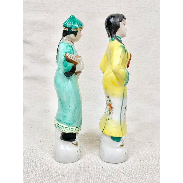 Colorful vintage figurines. I believe they are Chinese. Features a man and woman. Perfect to add to a vignette. These are...