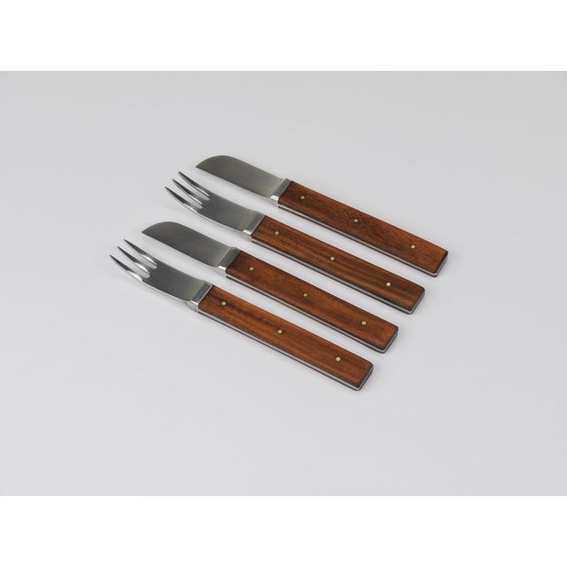 An elegant and understated 12-piece mid-century modern cutlery set designed by Austrian architect and designer Oswald...