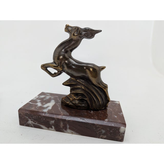 France, late 1920s or 1930s, probably cast zinc or bronze, patinated, reddish-brown marble base, good condition