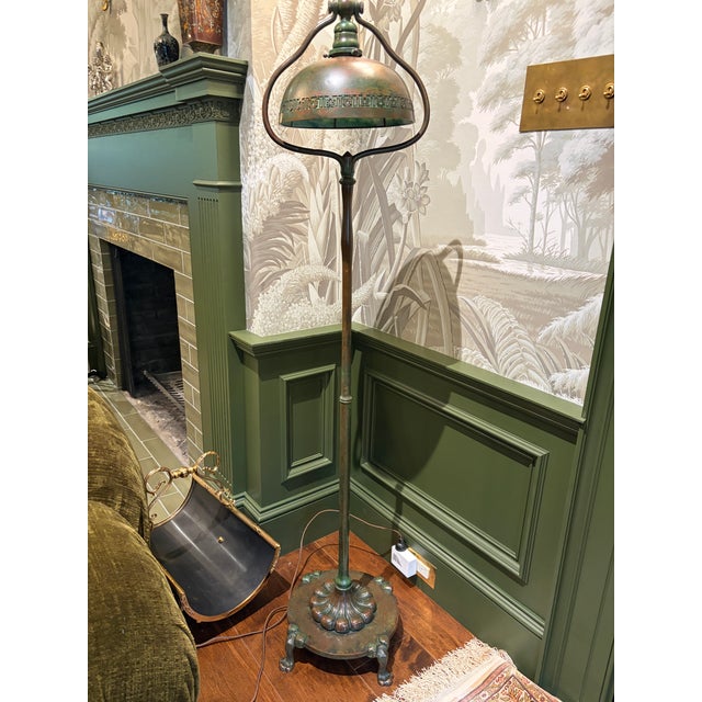 An exceptional and rare early 20th-century bronze harp floor lamp by the iconic Tiffany Studios, New York, featuring a...