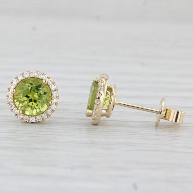Gemstone Information: - Natural Peridots - Total Carats - 2.90ctw Cut - Round Color - Light Green - Natural Diamonds -...