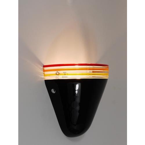 One single wall light from the 1980s, designed by Roberto Pamio and Renato Toso for Leucos in Italy. Stripped down to its...