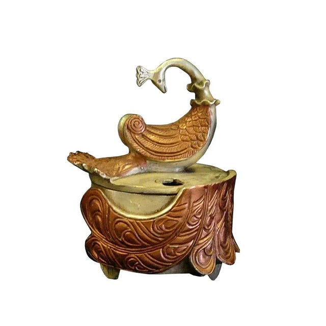 We love the elegant, brushstroke-like curves of this peacock-shaped incense burner. Origin: China Material: Mixed Material...