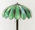 Tiffany Style Slag Glass Table Lamp, the floriform shade with green slag glass panels, the patinated bronzed base cast...