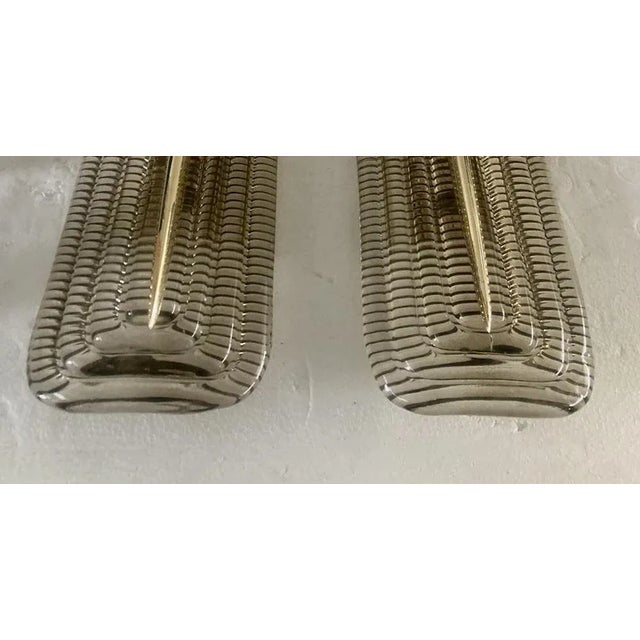 Very original Murano glass wall lamp with a very elongated design of the glass plate and a unique smoky color. The...