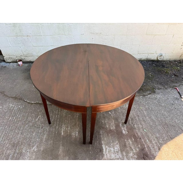 Pair of Antique Federal Style Mahogany Demilune Consoler Tables. It features wiith square tapering legs and each forming a...