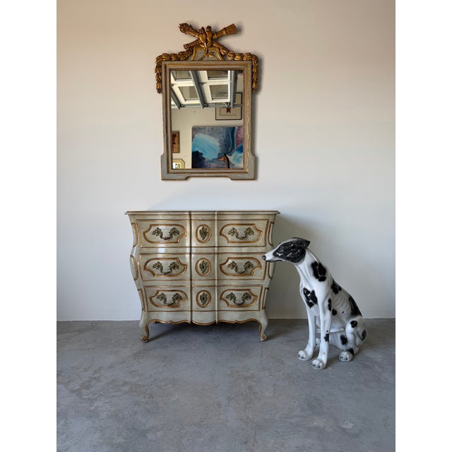 Elegant 1960s Italian Hollywood Regency wall mirror featuring a beautifully carved wood frame with hand-applied gilt...