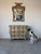 Elegant 1960s Italian Hollywood Regency wall mirror featuring a beautifully carved wood frame with hand-applied gilt...
