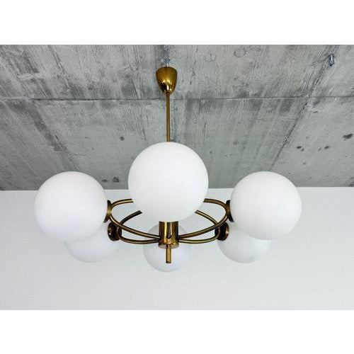 A striking and elegant six-light Mid-Century Modern chandelier, manufactured in Czechoslovakia during the 1960s. This...