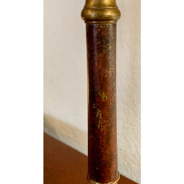 Offering a pair of tall brass candlesticks with decorative beads (removable). Finely cast with faux stone insert.